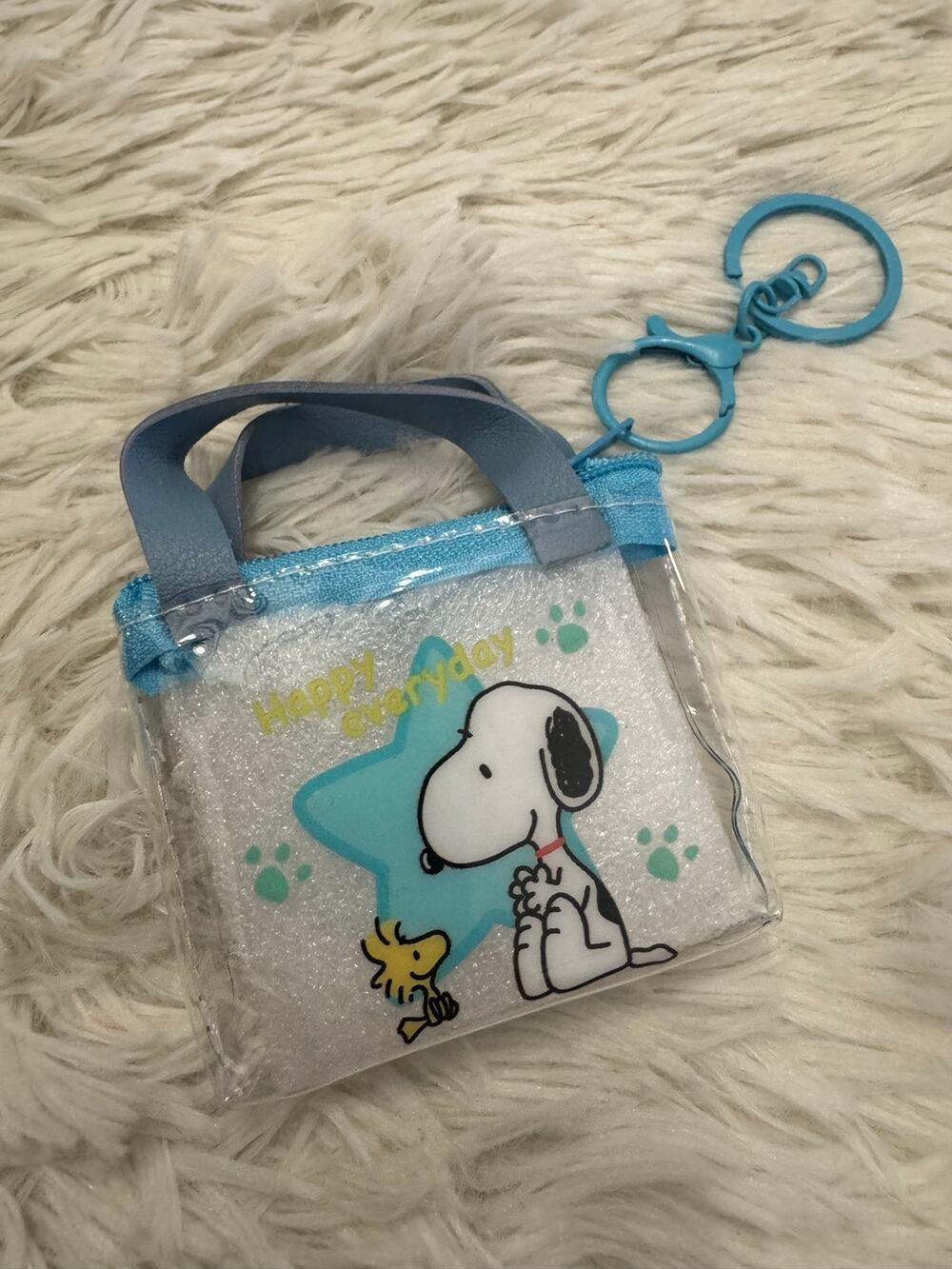 Snoopy clear mini purse keychain with blue star and yellow text 'Happy everyday'